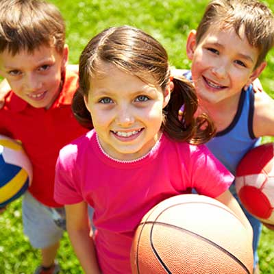 young kids with sports equipment